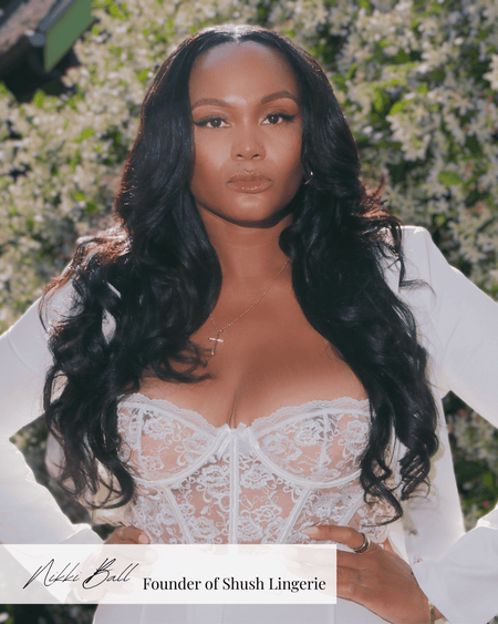 Nikki, founder of Shush Lingerie, wearing a white lace bustier outdoors in California, empowering women through inclusive bra fittings.